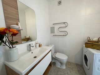 Bathroom with various household accessories and appliances.