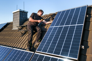 Person inspecting the photovoltaic system on the roof of a house