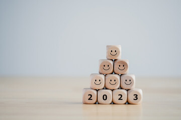 2023 wooden blocks with happy face. Happy new year, Happy life. New year positive emotion. Mental...