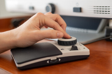 A woman uses a special magnification device for the visually impaired.