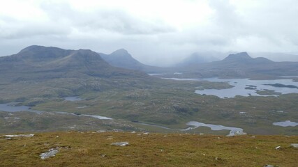 Misty view of hills and dry field with fishing spots