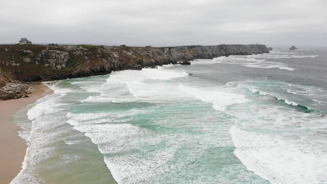 Coastline with promontory Pointe du Raz and sandy beach in Crozon peninsula, Brittany, France.