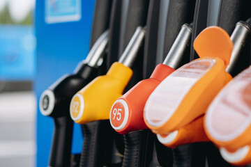 petrol pump filling fuel nozzles at gas station