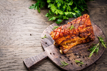 Roasted pork belly with crust and herbs