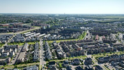 Drone shot of the Assendelft town with organized lanes houses and streets in The Netherlands