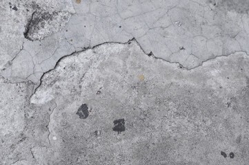 cracks on white-gray concrete floor with empty space