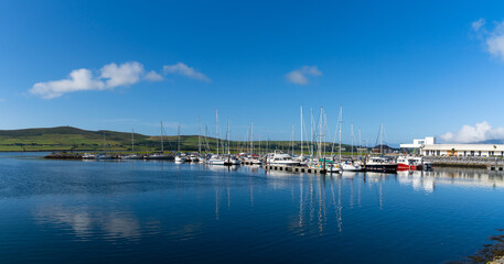 Fototapeta na wymiar view of many sailboats in the marina and harbor in Dingle village in County Kerry