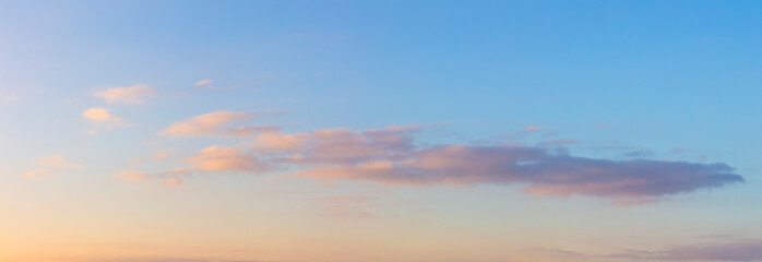 Soft gentle clouds in the morning sky. Soft haze and pastel colors of dawn.
