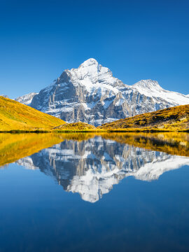 High mountains and reflection on the surface of the lake. Mountain valley with lake. Landscape in the highlands in the summertime.