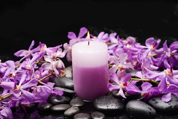 Keuken spatwand met foto spa still life of with  branch  orchid ,candle  and zen black stones wet background  © Mee Ting