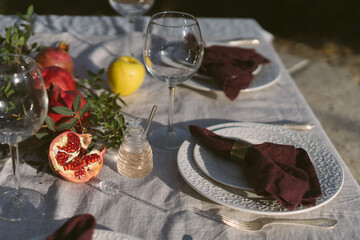 Table set with linen tablecloth and napkins for feast of Rosh Hashana, new Jewish year start , with...