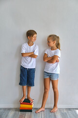 Cool kids, little boy and girl measure their height a