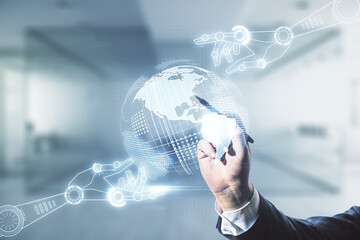 Double exposure of male hand with pen draws abstract virtual robotics technology with world map hologram on blurred office background. Research and development software concept