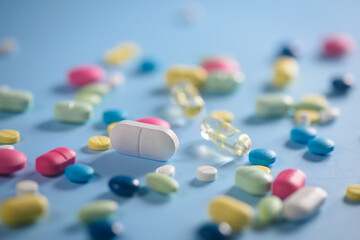 Pharmacy background on a  table. Tablets on a blue background. Pills. Medicine and healthy. Close up of capsules. Different kind of medicines