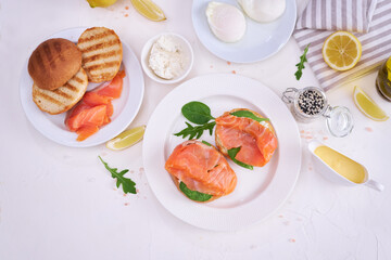 Making cream cheese and salmon toatst - woman smearing cream cheese on a grilled bun
