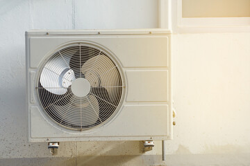 Fototapeta premium air conditioner compressor installed on the outside of the building. Soft and selective focus.