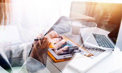 Woman accountant use calculator and computer with holding pen on