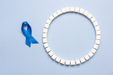 World Diabetes Day conceptual background, blue ribbon and sugar cubes ring