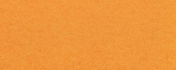 Texture of bright orange and red colors paper background, macro. Structure of dense ginger craft...