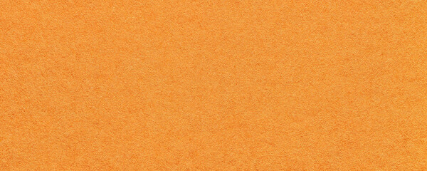 Texture of bright orange and red colors paper background, macro. Structure of dense ginger craft cardboard