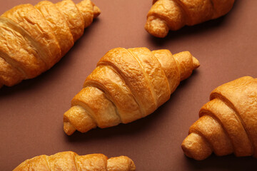 Freshly baked croissants on brown wooden background Warm Fresh Buttery Croissants and Rolls. French and American Croissants and Baked Pastries.