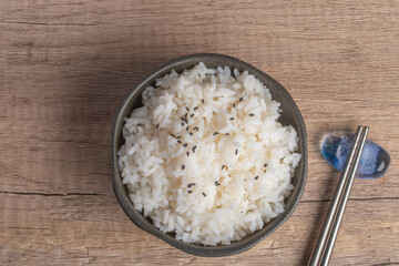 Cooked rice in a cup of black Thai jasmine rice