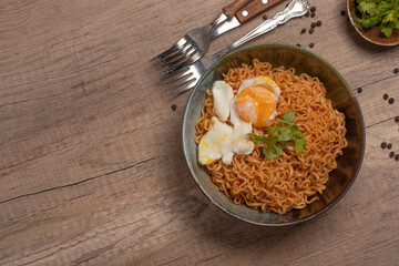 Instant noodles with boiled eggs. On wooden floor.