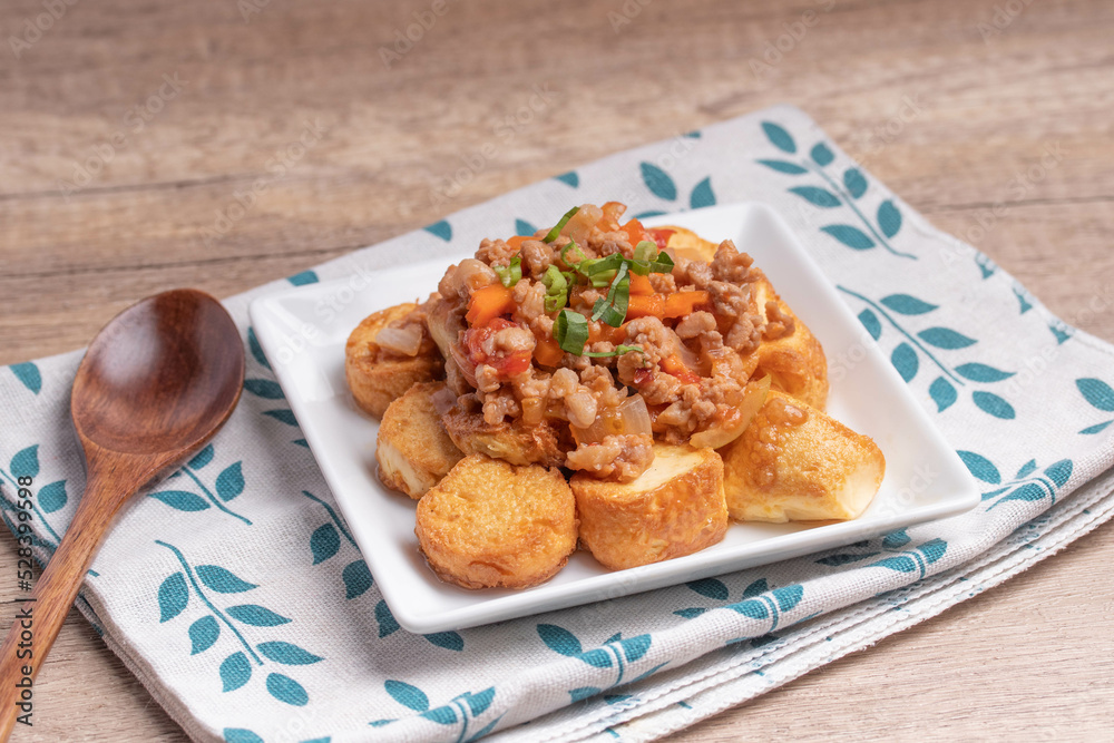 Poster Fried tofu stir fried with ground pork and vegetables in white plate