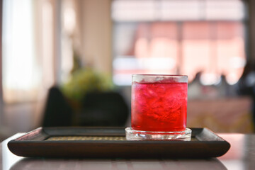 Red soda drink on wooden floor