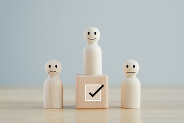 Select happy face figure on top of wooden blocks. Evaluation, Performance Appraisal, Skill, Success, Expert, Leadership. Human Resources management choosing positive attitude to team leader.