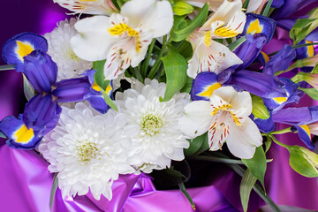 beautiful white chrysanthemums among other flowers in the bouquet.  selective focus, top view