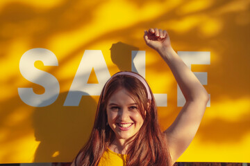 Happy woman with hand raised in front of sale sign
