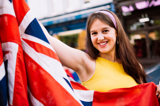 Happy woman holding British flag