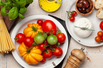 Various tomatoes, olives and burrata cheese