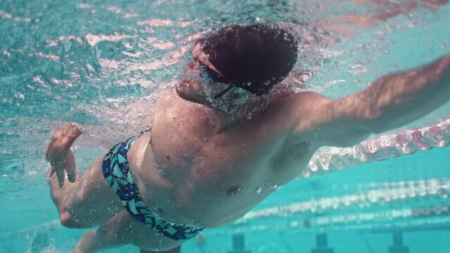 Close Up Underwater View Of Professional Athlete Swimming Freestyle And Breathing Bubbles, 4K