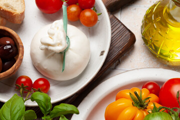 Burrata cheese, various tomatoes and olives