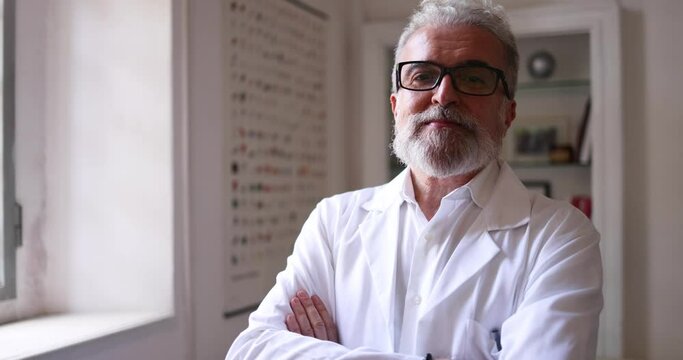 Confident scientist standing in laboratory with arms crossed