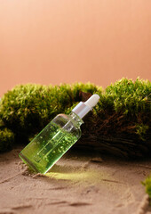 bottle of cosmetic serum on natural background with moss organic cosmetics	
