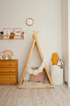Wooden triangle shape tent on floor at home