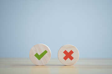 Green correct check mark and red wrong or cross icon on wooden circle for true or false changing...