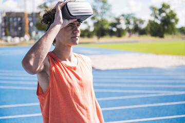 Sportsman with virtual reality simulator on sunny day