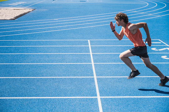 Young sportsman running on track