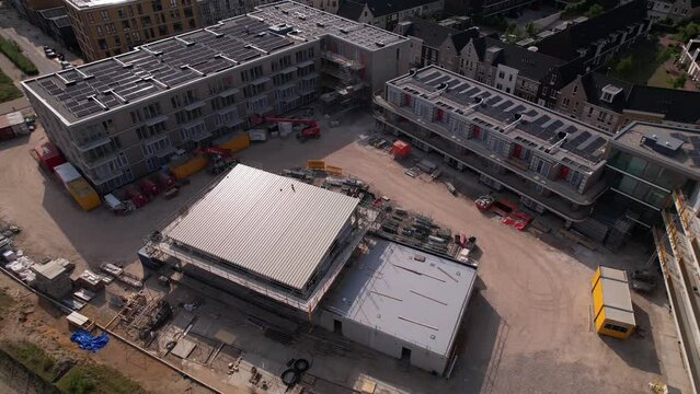 Rotating aerial movement showing construction site Ubuntuplein revealing urban development real estate investment project in new Noorderhaven neighbourhood.