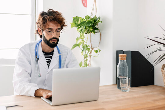 Doctor Using Laptop Working From Home Office