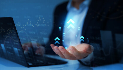 Businessman holding arrow up with graph of business analysis. Business development, financial plan and strategy.Investment of growth on currency rate.