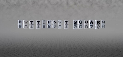 butternut squash word or concept represented by black and white letter cubes on a grey horizon background stretching to infinity