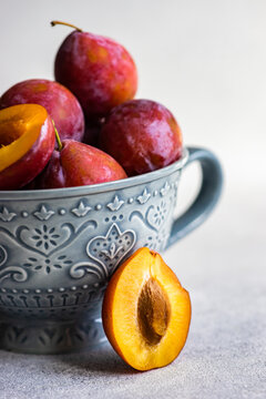 Close-Up of organic red ripe plums in a bowl