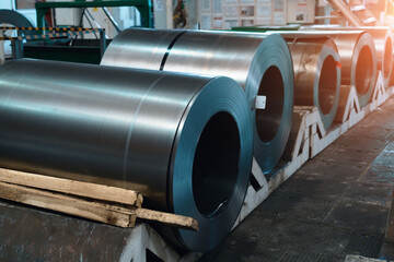 Fototapeta na wymiar Rolls of steel sheets. Metal coils in metalwork factory workshop.