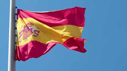 Spain, flag is fluttering in the wind photo on the background of the sky, outdoors. National flag