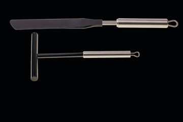 Close up view of kitchen utensils for making pancakes isolated on black background.